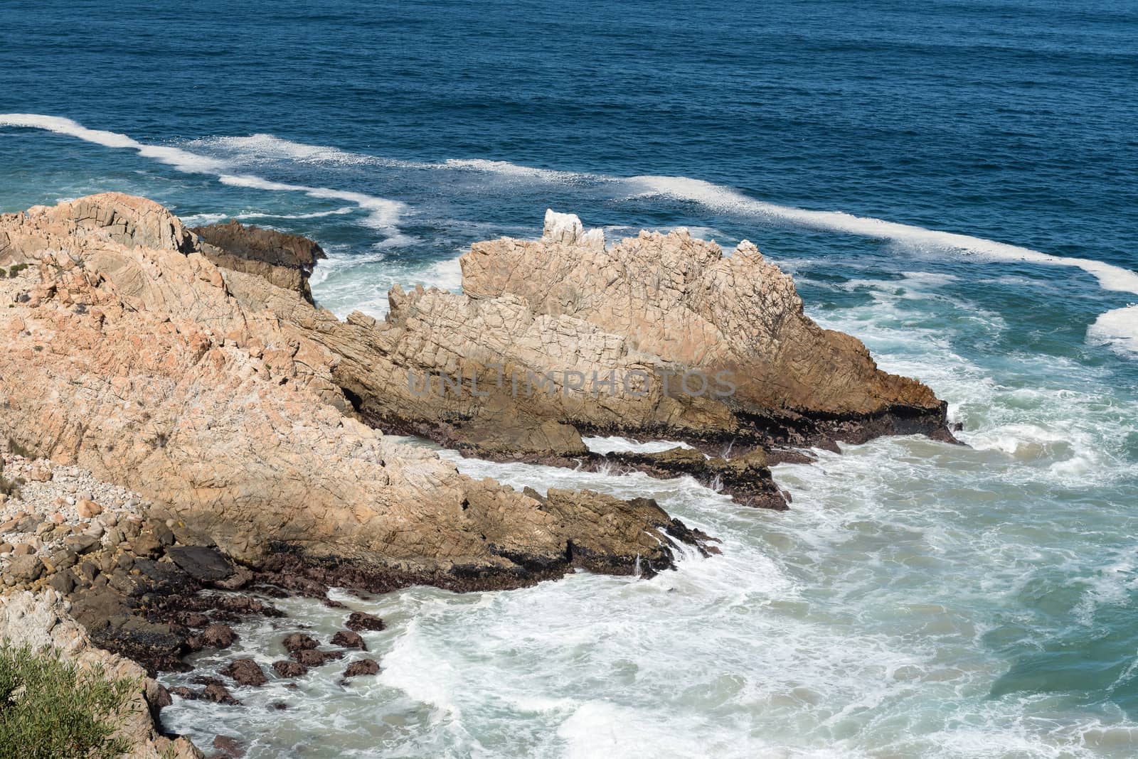 A rocky outcrop, resembling a dragon, in the sea next to Clarence Drive between Gordons Bay and Rooi-Els