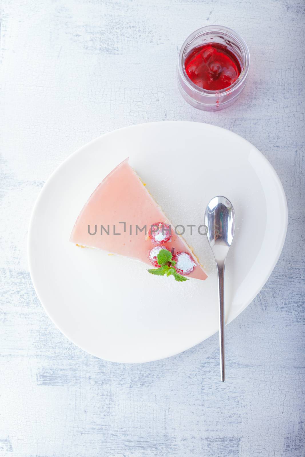 Piece of raspberry yogurt cake and raspberry sauce