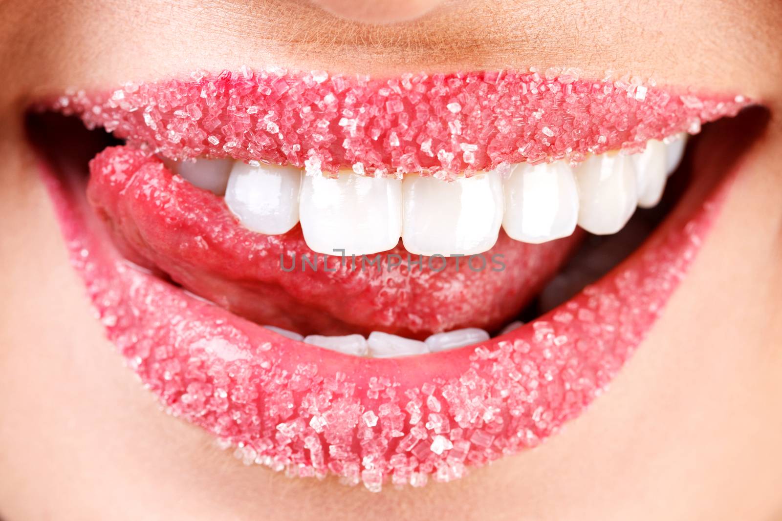 Closeup of woman's lips covered with sugar. Toothy smile by Nobilior