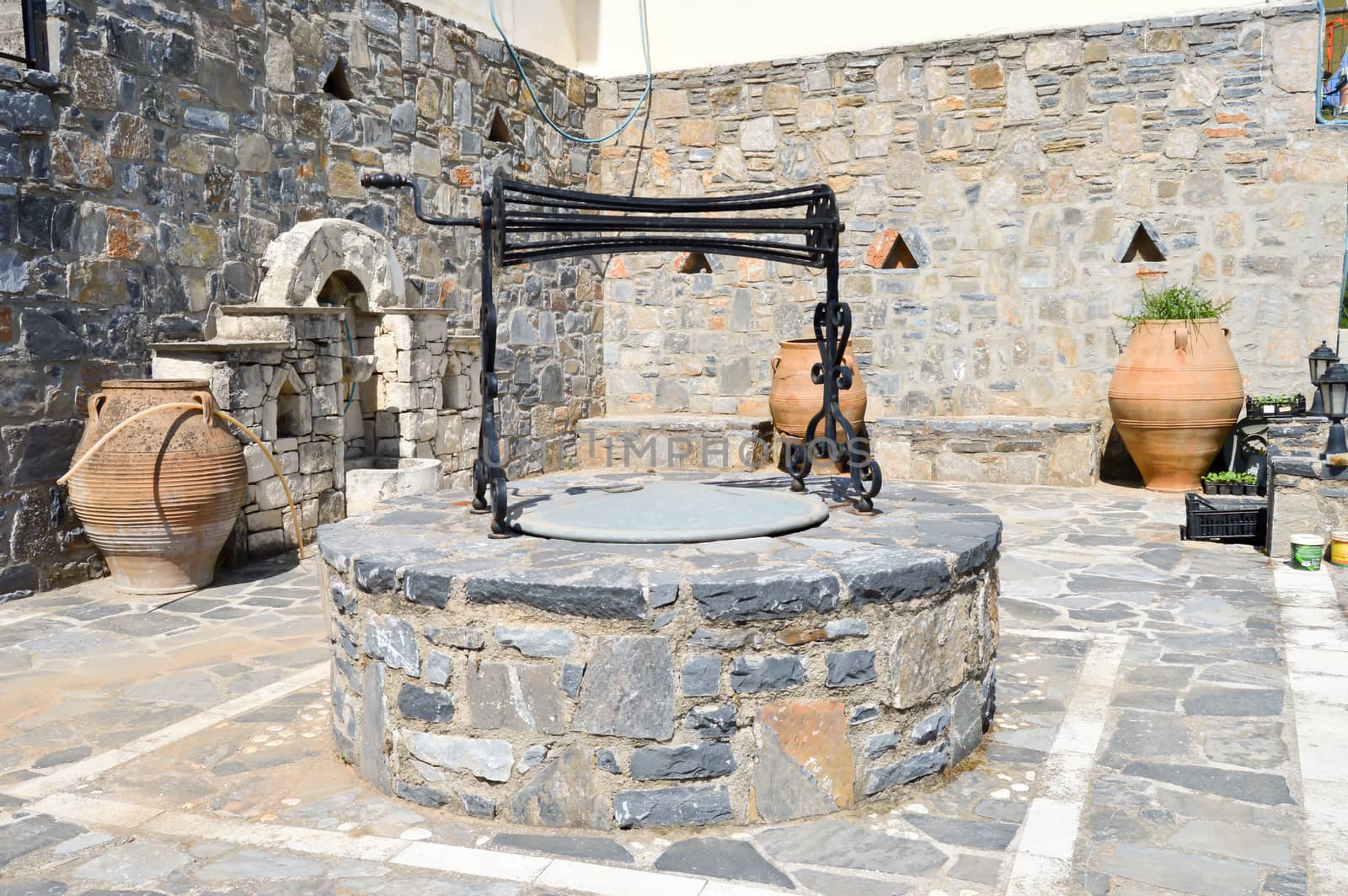 Old well with amphorae in a village in the center of Crete