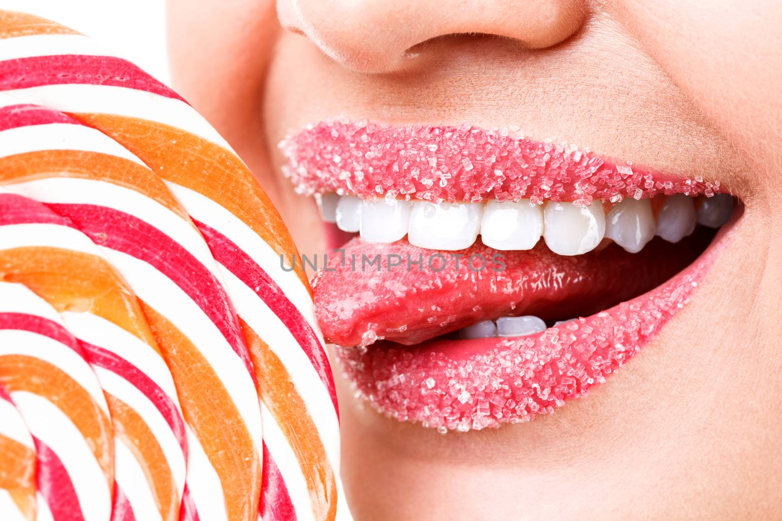 Closeup of woman's lips covered by sugar and big lollipop by Nobilior