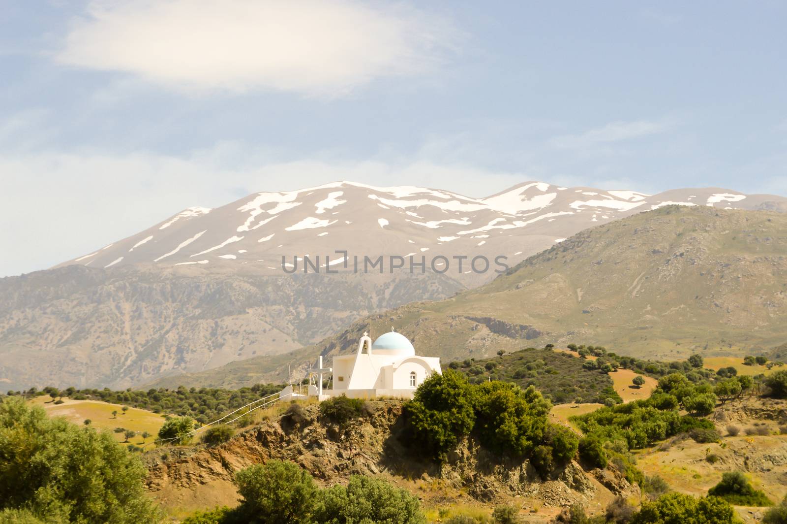 Greek Orthodox Church on a hill with the bottom of the mountain in the center of Crete