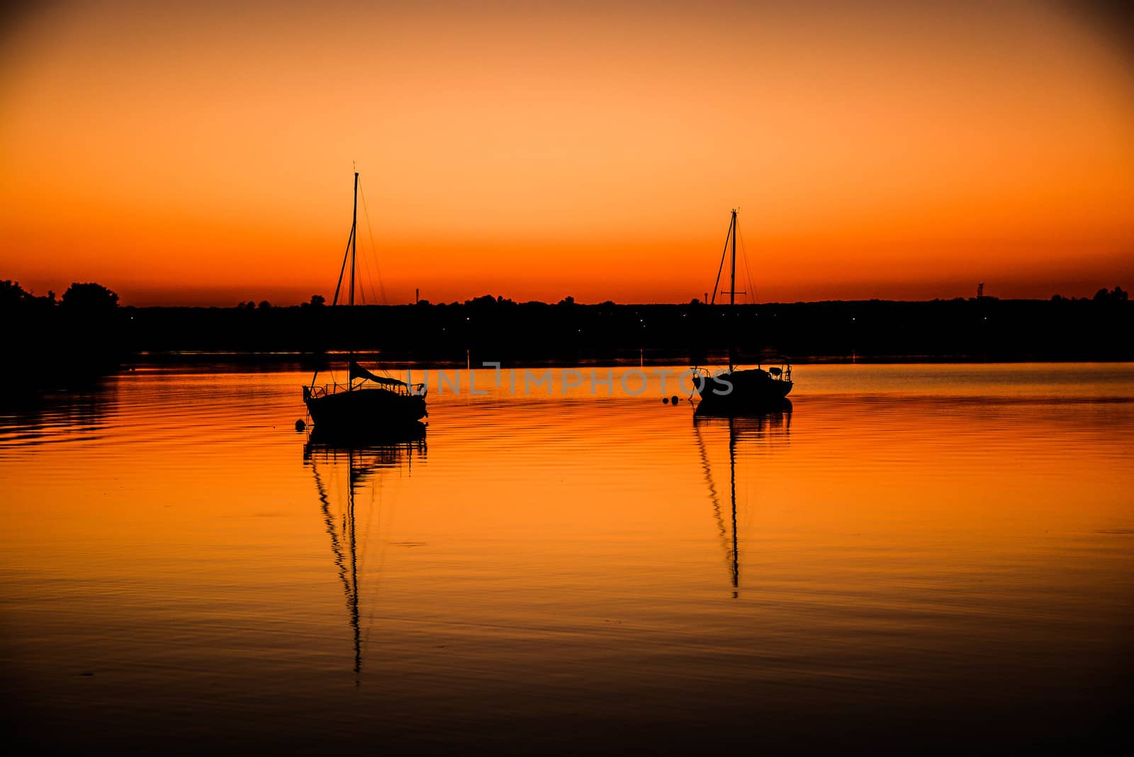 Two boats at sunset on northern lake