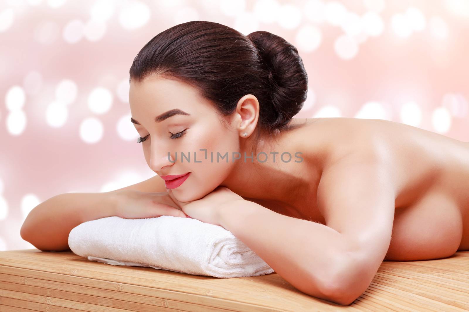 Young beautiful woman relaxing at spa salon. Abstract background by Nobilior