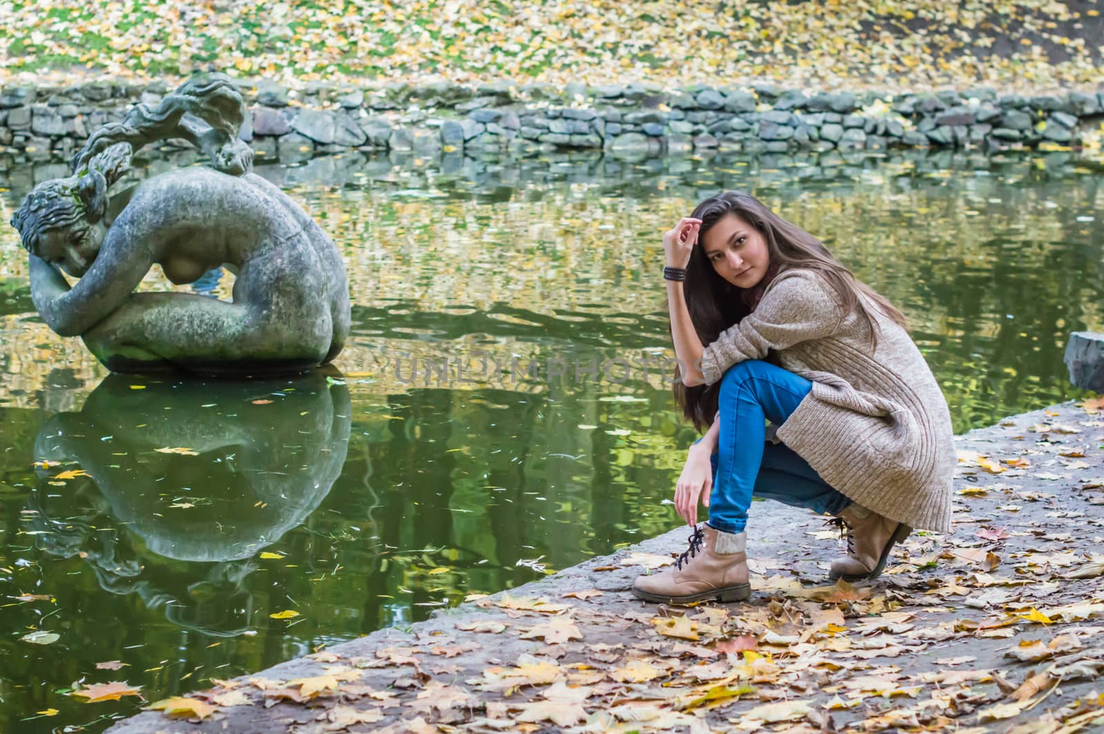 beauty girl sitting near the pond by okskukuruza