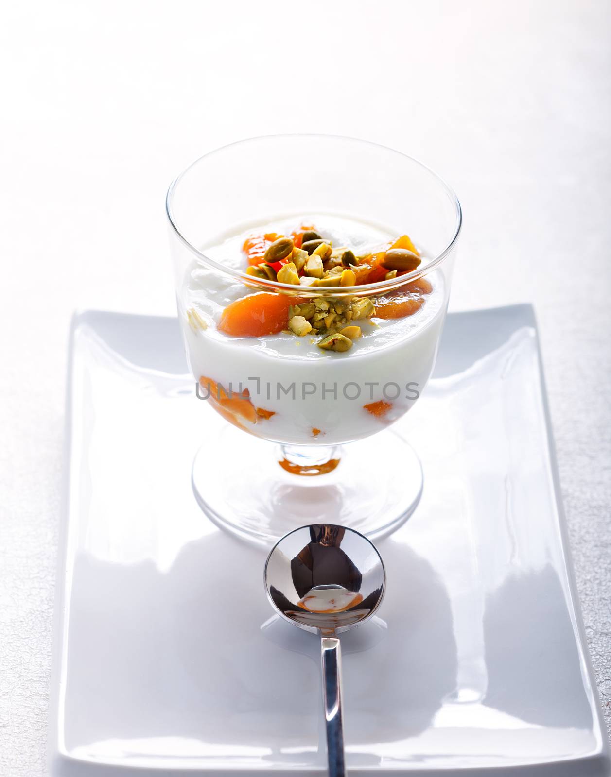 A glass of Homemade yogurt with dried apricots