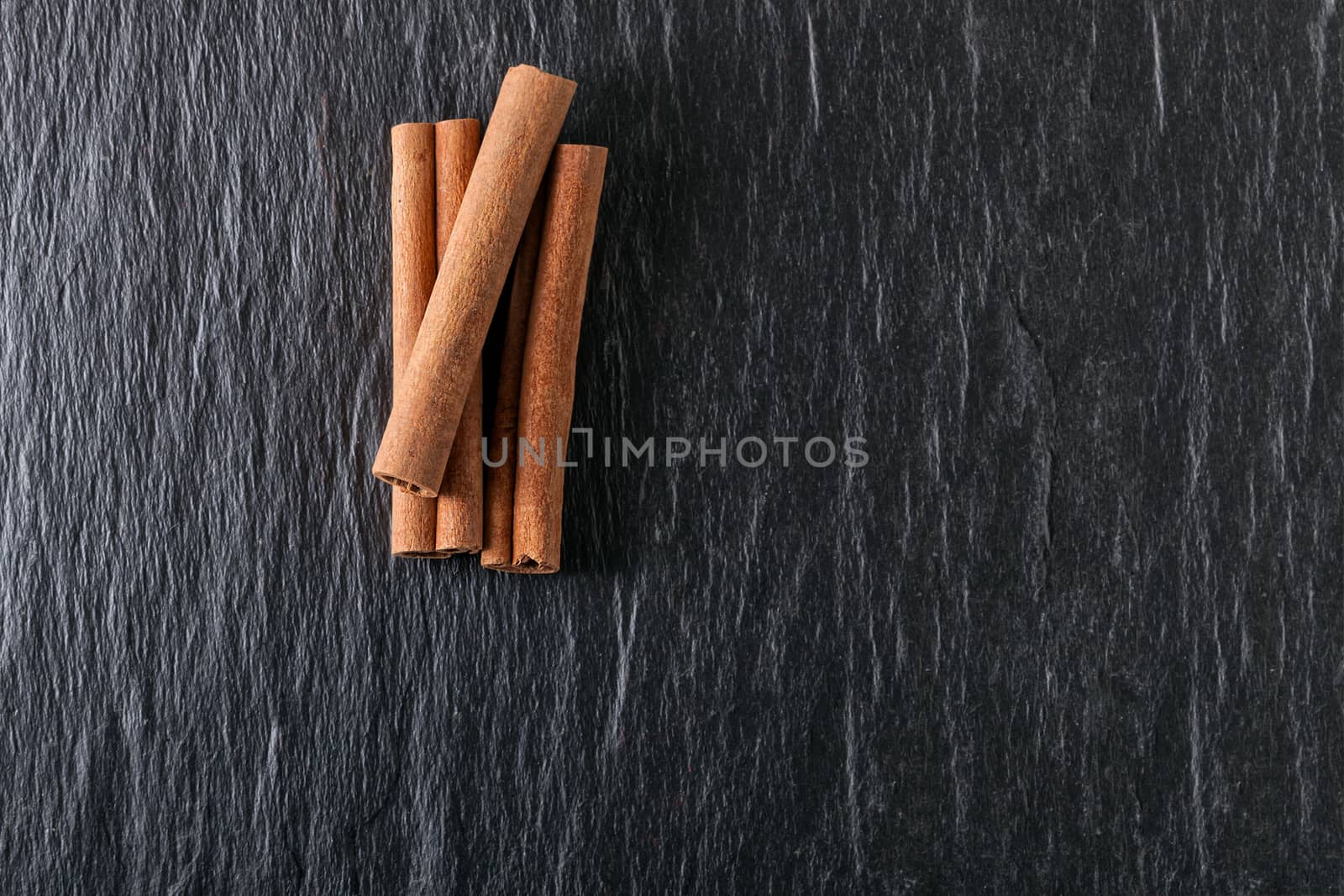 A bunch of Cinnamon sticks on a stone plate