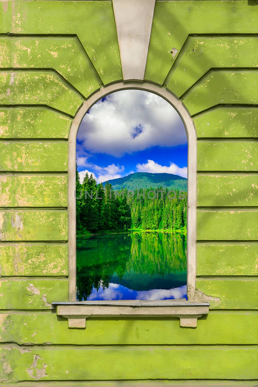 old window frame on the wall with picture of mountain lake