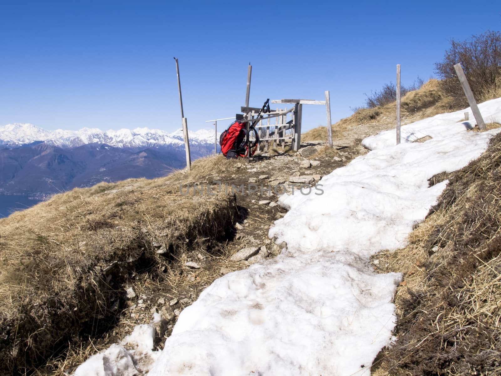 Montelema, Ticino - Switzerland: Trekking backpack resting on the ground with snow last season