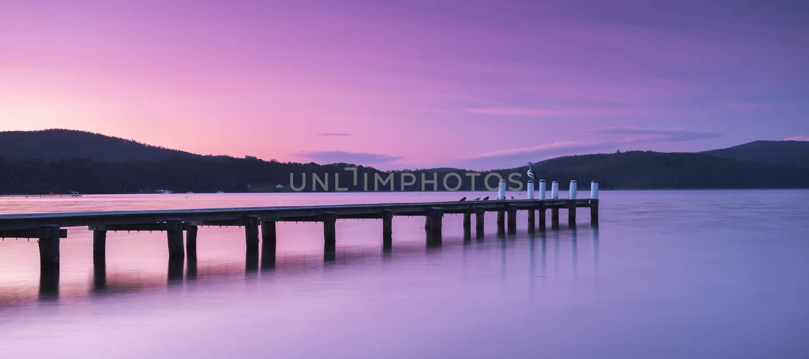 Port Arthur pier and hillside at dusk in Tasmania, Australia.