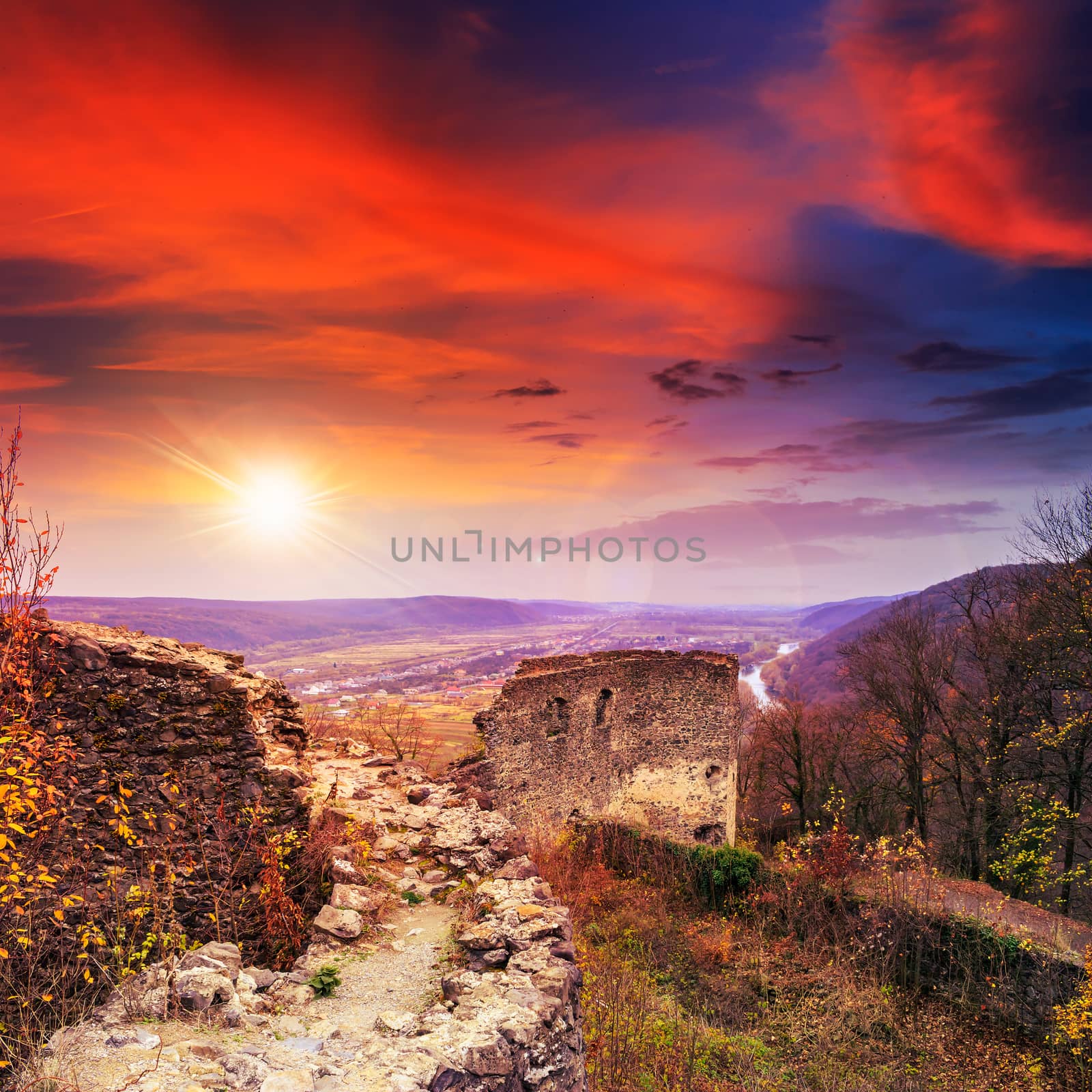 ruins of an old castle in the mountains at sunset by Pellinni