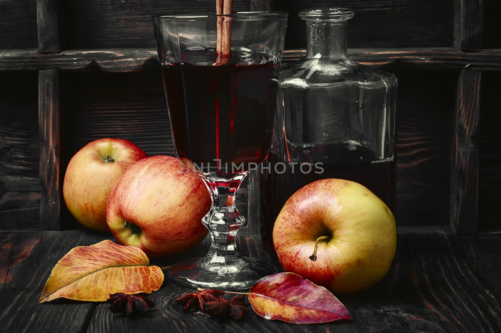 Warming autumn cocktail sangria with apple in glass wine glass.Dark key