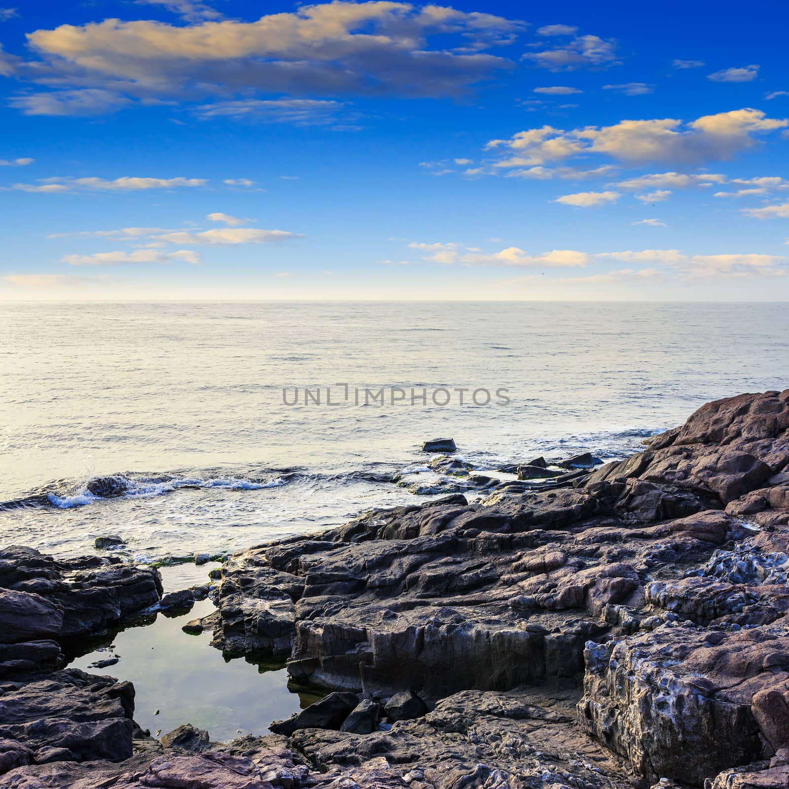 sea wave breaks about boulders by Pellinni