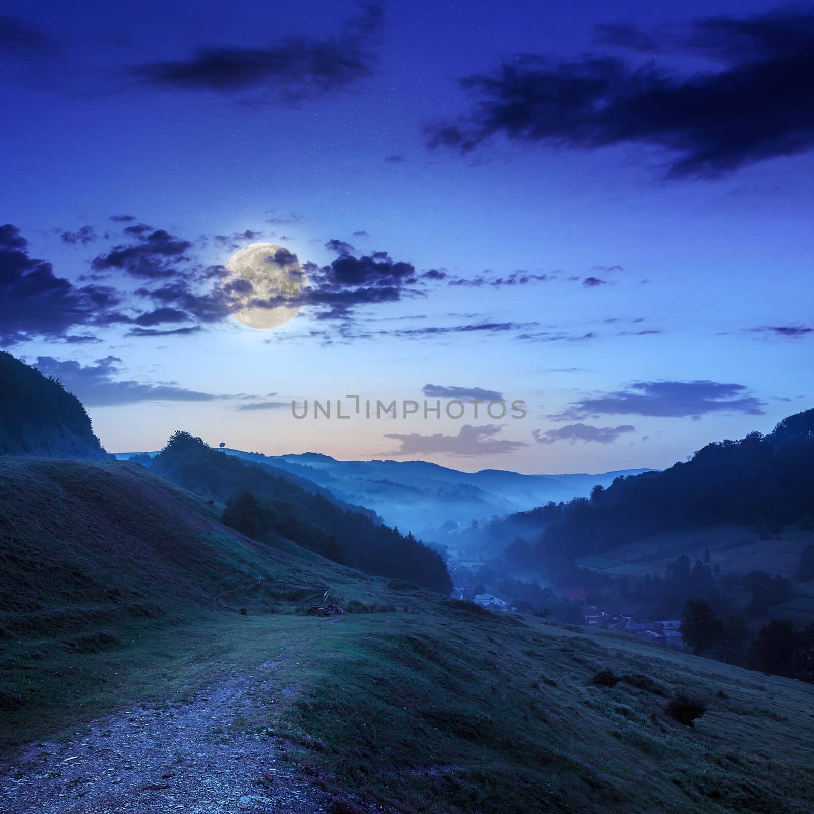 village in cold fog  in the mountains at night in moon light