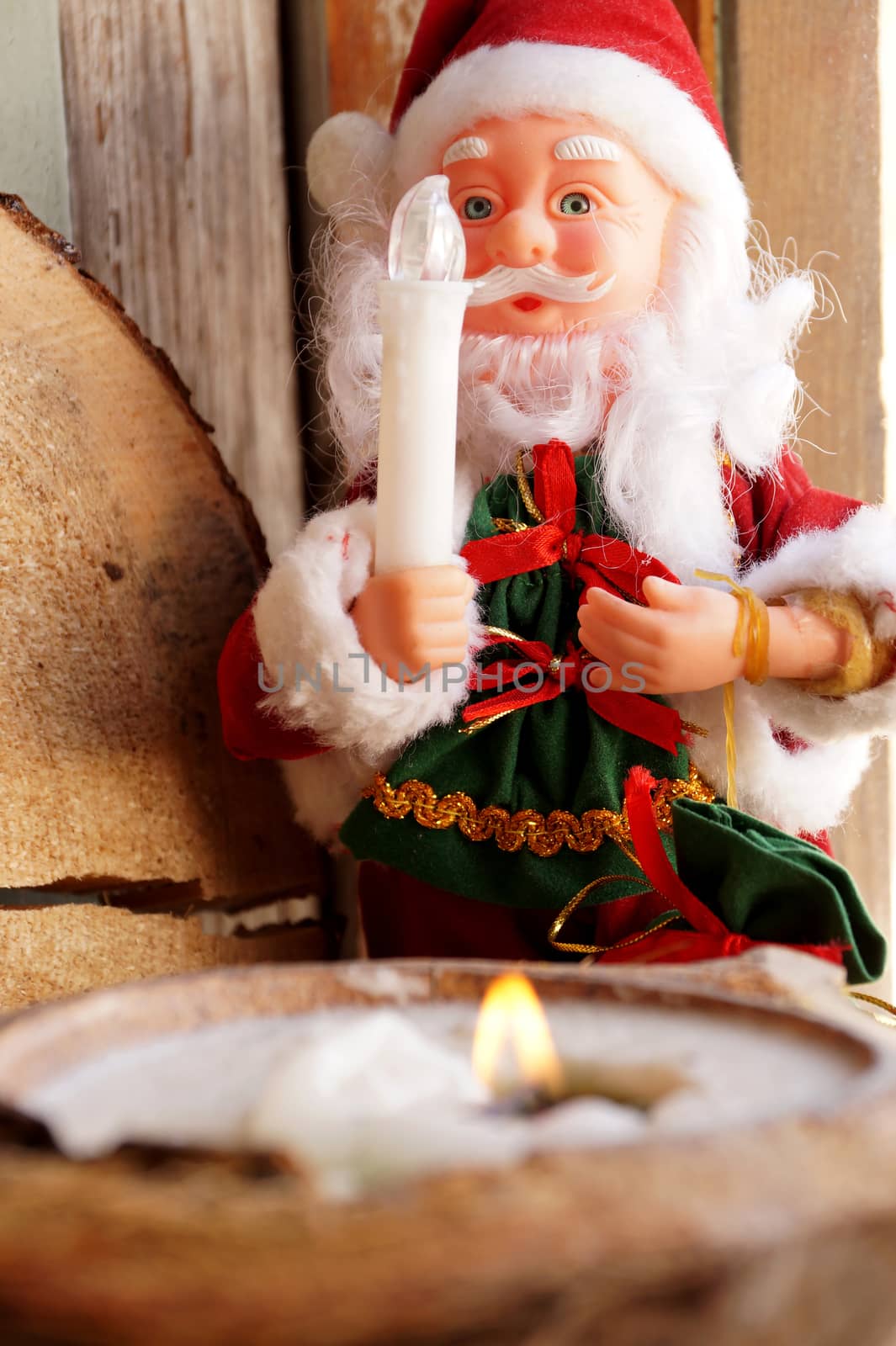 Santa Claus and a candle in a coconut by Vadimdem