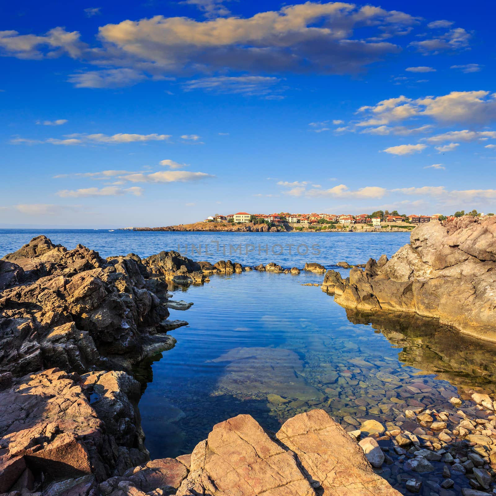 sea coast  with giant boulders against the old city