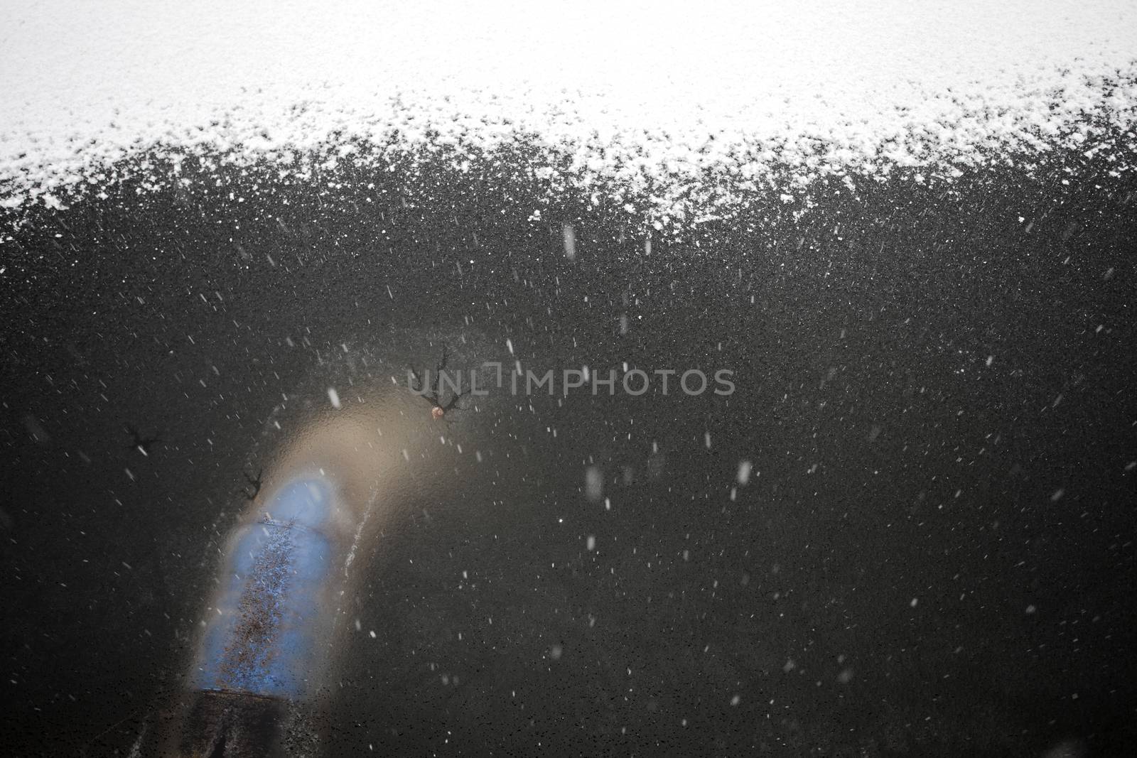 abstract snow falling on a frozen lake with a pipe