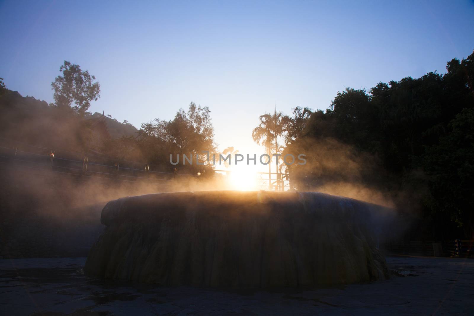 volcanic natural hot spring mineral water pool with steam spa and sun reflect light travel landmark background lampang thailand landscape colorful dark tone