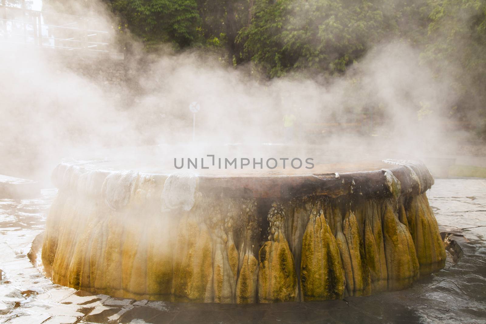 volcanic natural hot spring mineral water pool with steam spa and sun reflect light travel landmark background lampang thailand landscape colorful dark tone