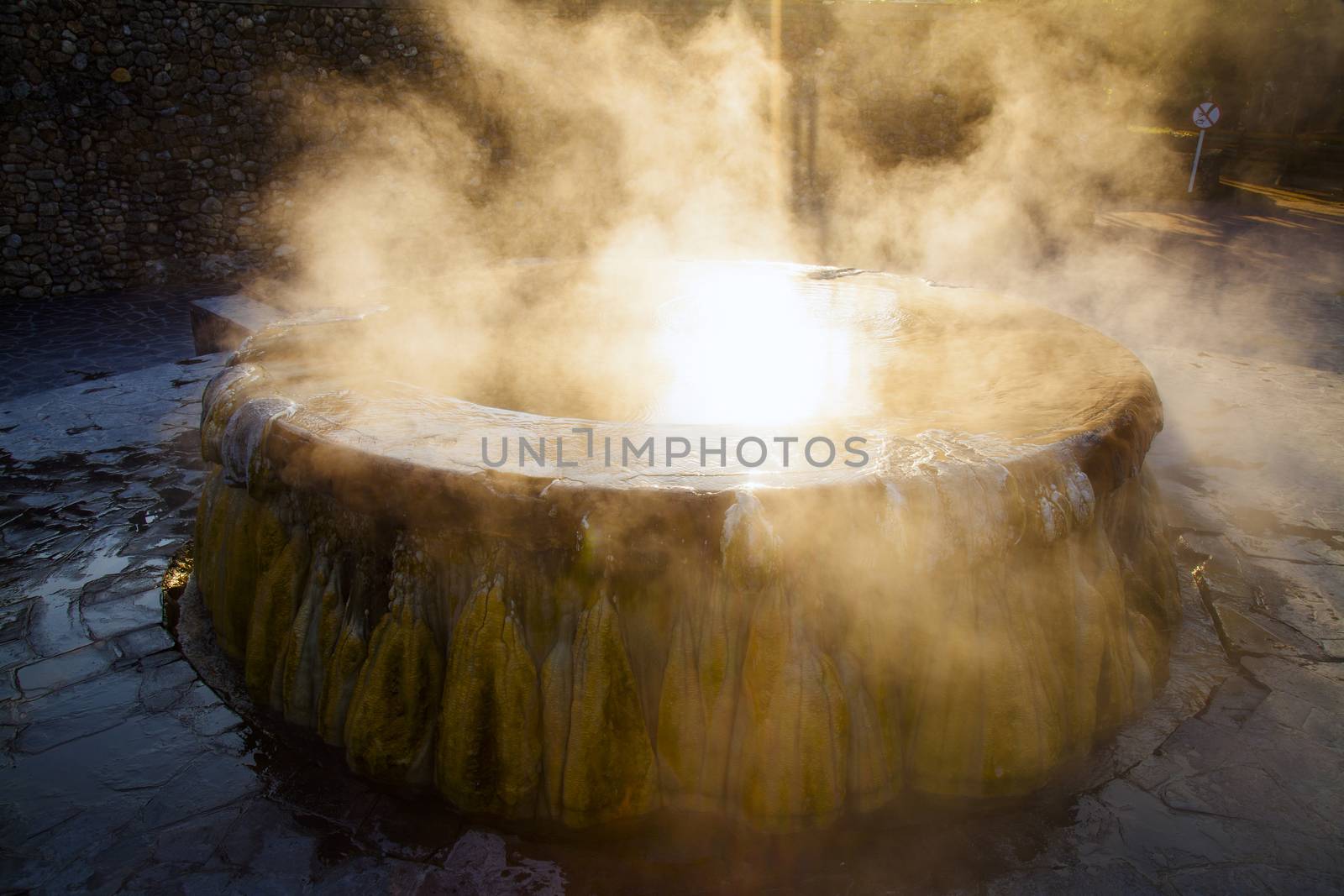 volcanic natural hot spring mineral water pool with steam spa and sun reflect light travel landmark background lampang thailand landscape colorful dark tone, Ruksavarin Hot Spring 
Ranong Thailand.