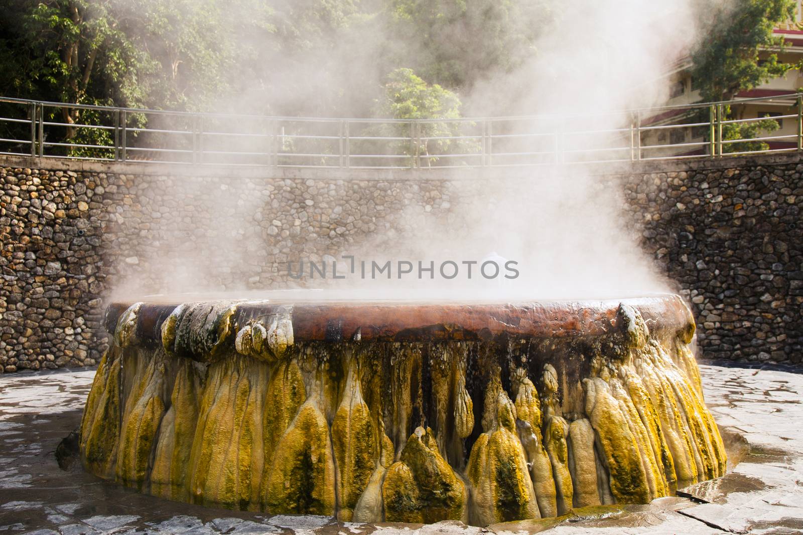 volcanic natural hot spring mineral water pool with steam spa and sun reflect light travel landmark background lampang thailand landscape colorful dark tone, Ruksavarin Hot Spring 
Ranong Thailand.