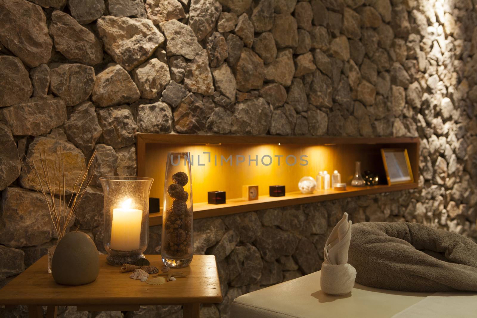 Interior of modern massage room in candle light, Romantic Spa Room.