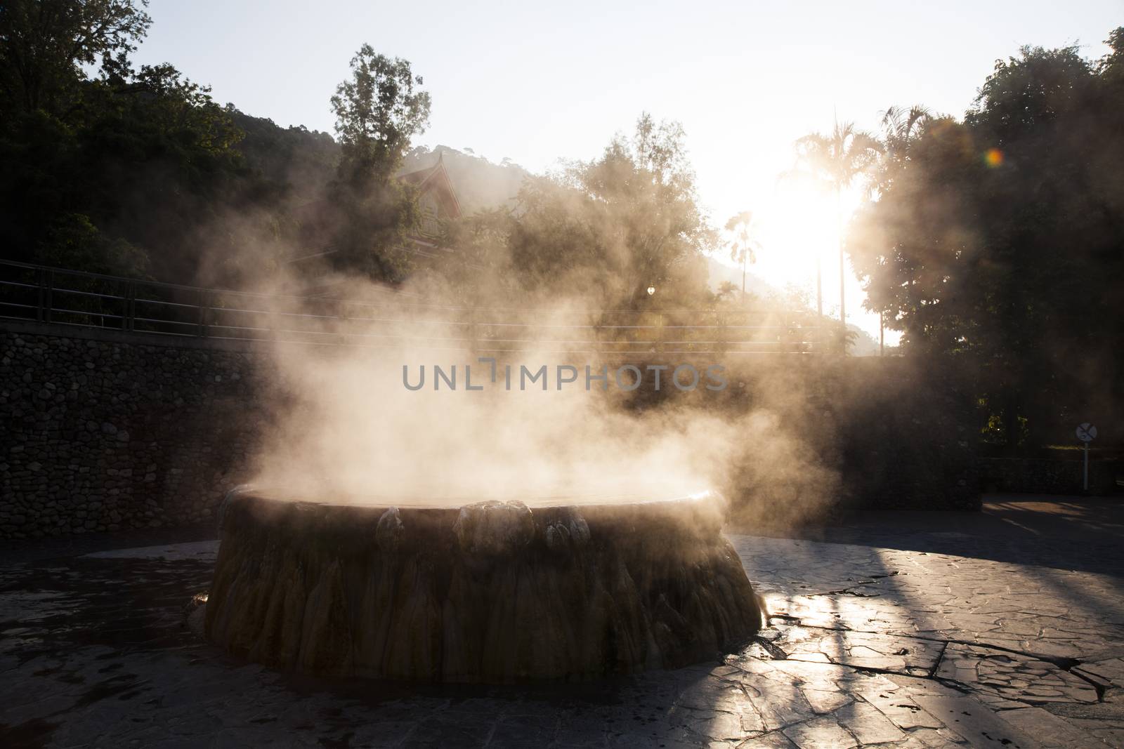 volcanic natural hot spring mineral water pool with steam spa and sun reflect light travel landmark background lampang thailand landscape colorful dark tone, Ruksavarin Hot Spring 
Ranong Thailand.