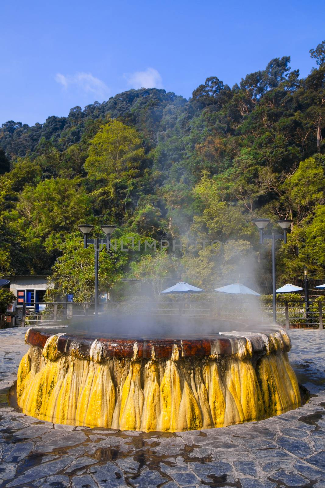 volcanic natural hot spring mineral water pool with steam spa and sun reflect light travel landmark background lampang thailand landscape colorful dark tone, Ruksavarin Hot Spring 
Ranong Thailand.