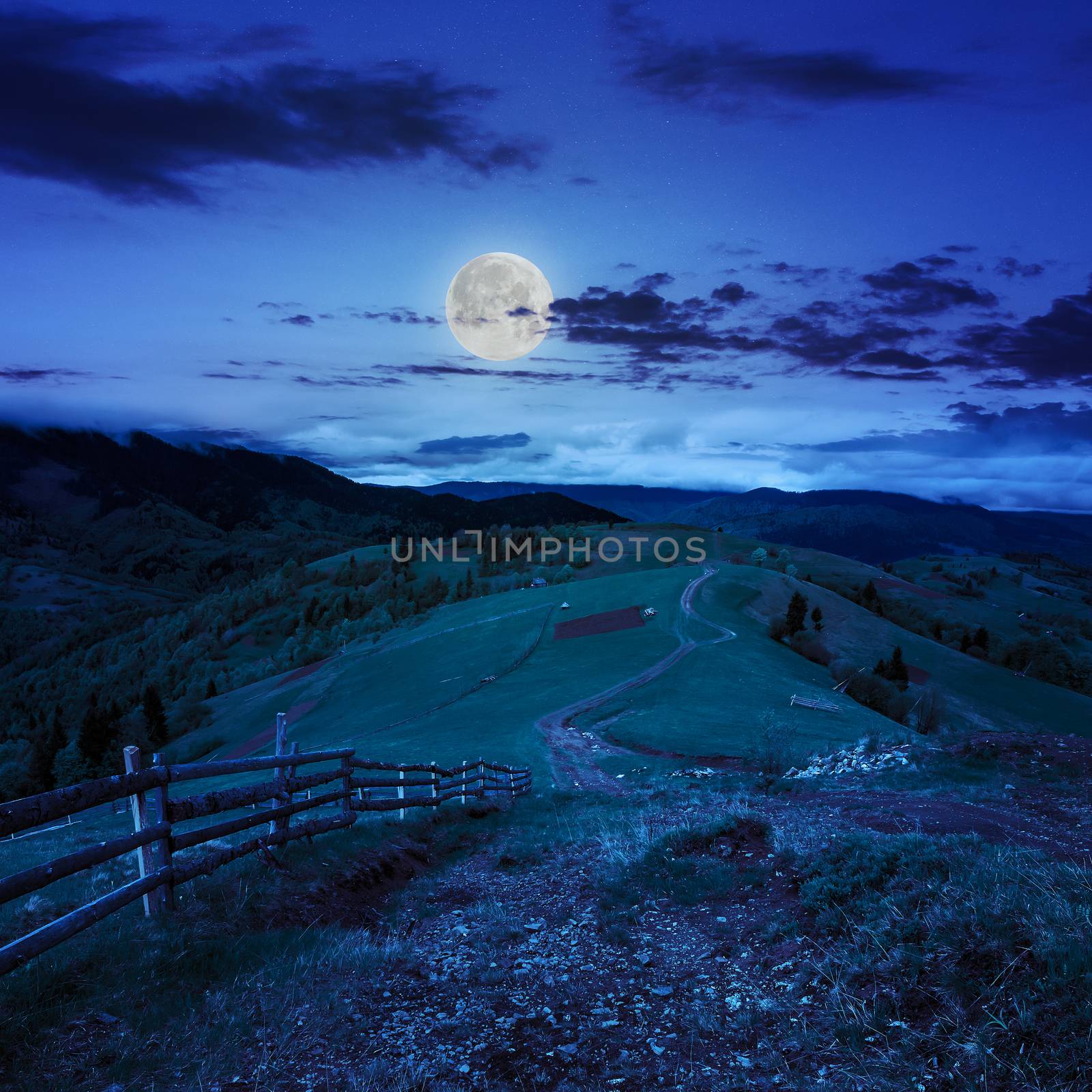 fence on hillside meadow in mountain at night by Pellinni