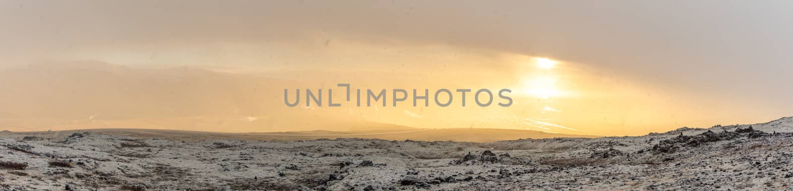 Snowy Winter Mountain range with sun light in Reykjavik Iceland panorama
