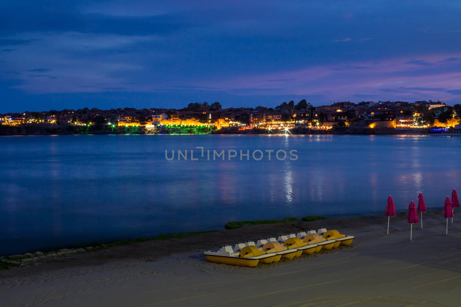 sea waves breaking on the sandy beach at night by Pellinni