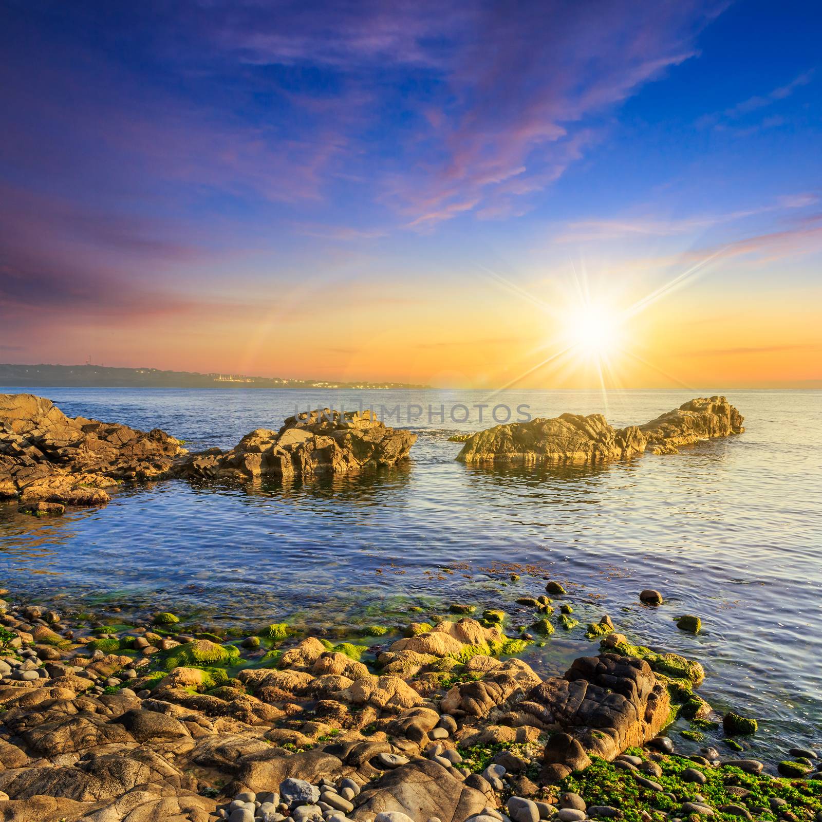 calm sea wave wash boulders at sunset by Pellinni