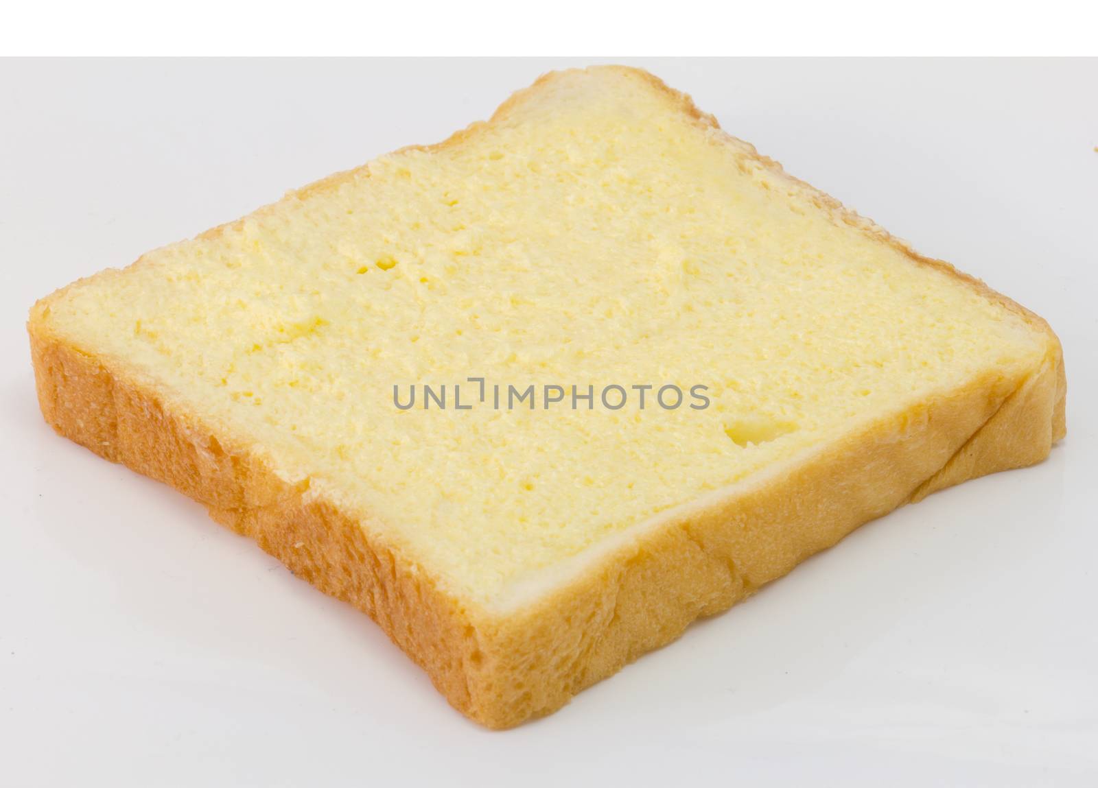 Sliced bread with sugar and butter on top isolated on white by chingraph