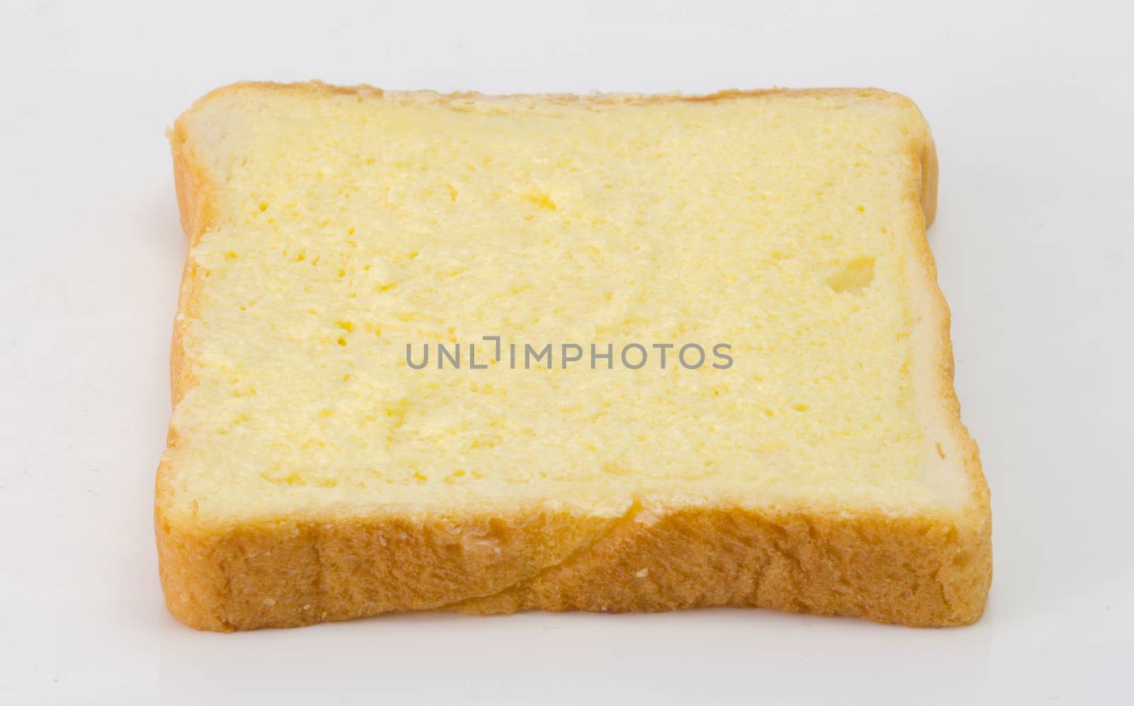 Sliced bread with sugar and butter on top isolated on white