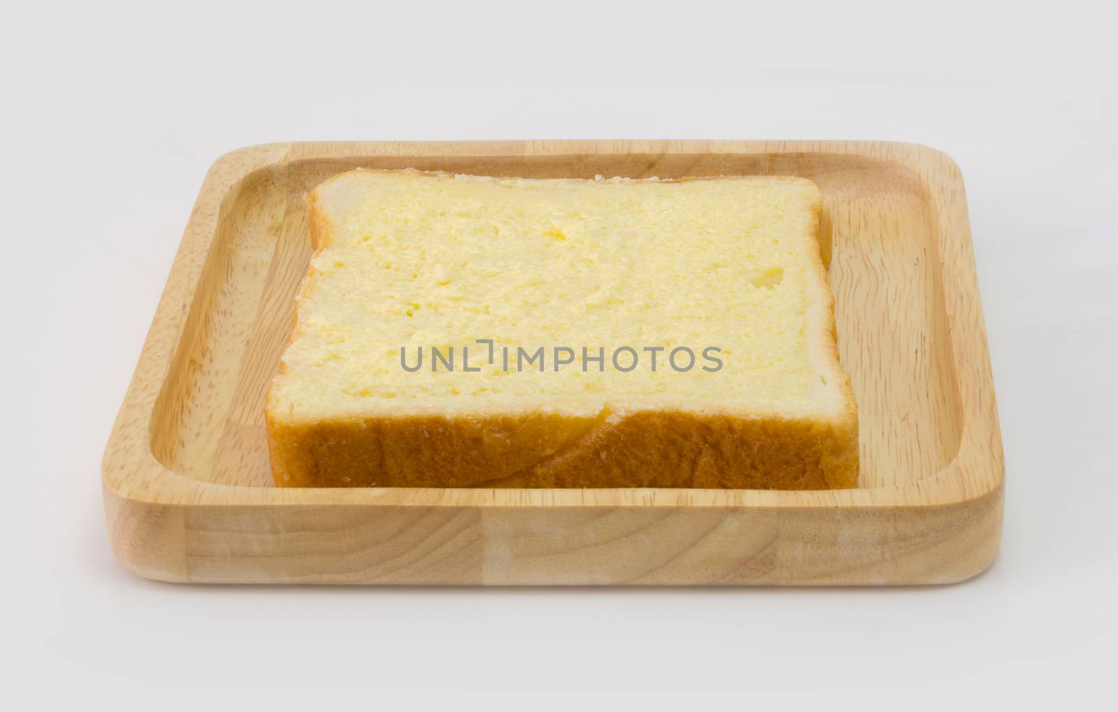 Sliced bread with sugar and butter on top isolated on white