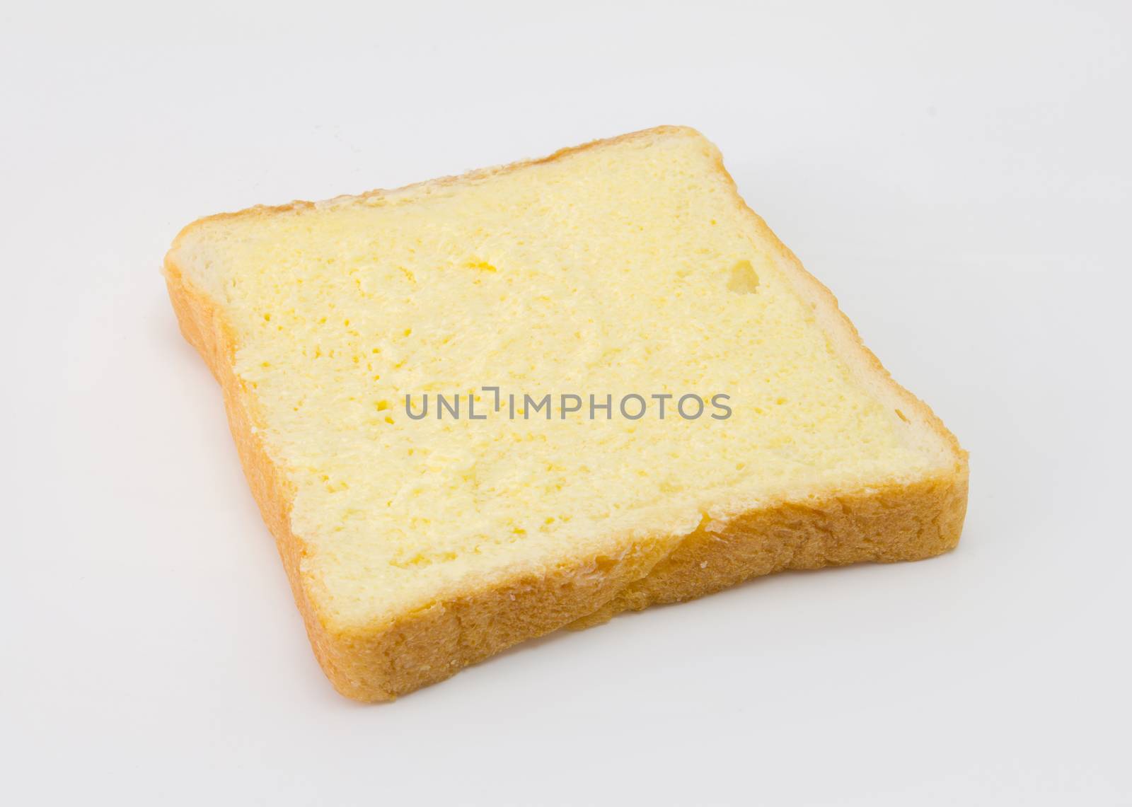 Sliced bread with sugar and butter on top isolated on white