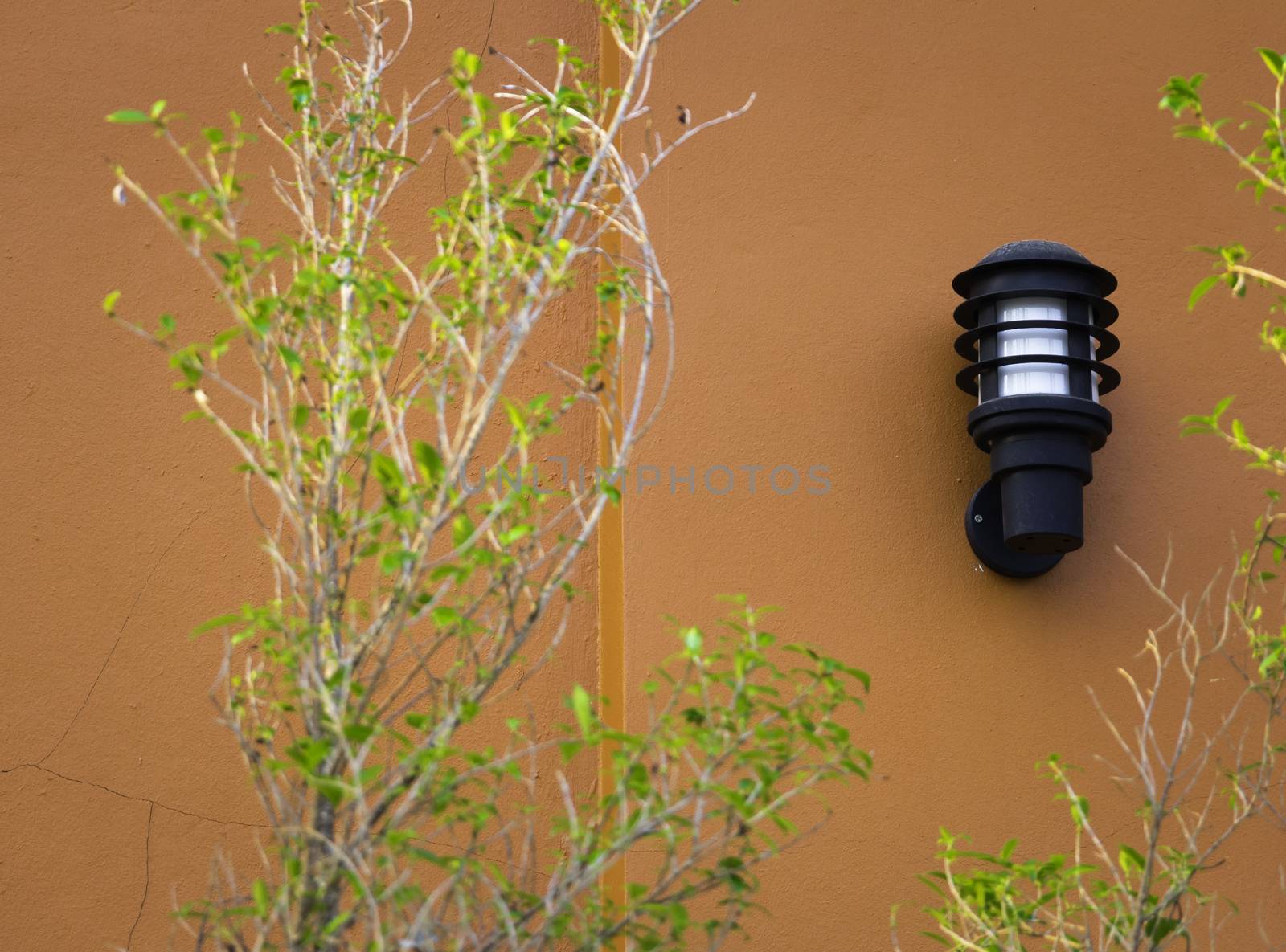 wall lamp on orange outdoor wall, black outdoor lamp by chingraph