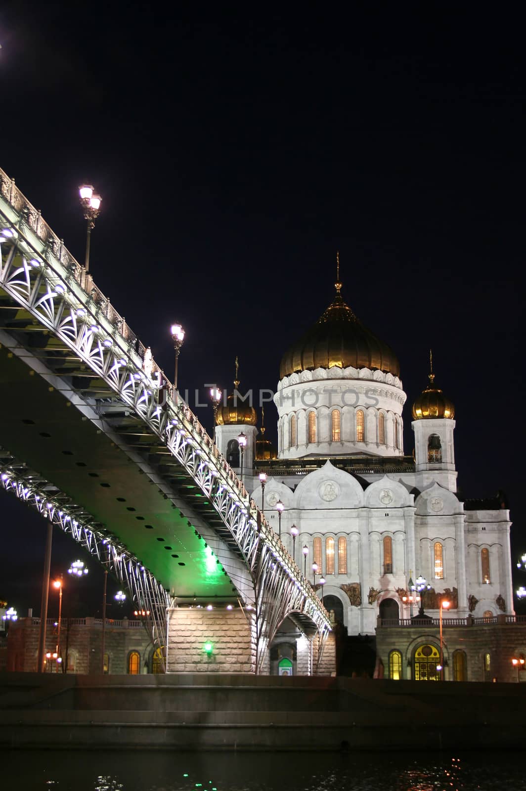 Night landscape the bridge through the Moskva River and the Cathedral of Christ the Saviour in the city of Moscow