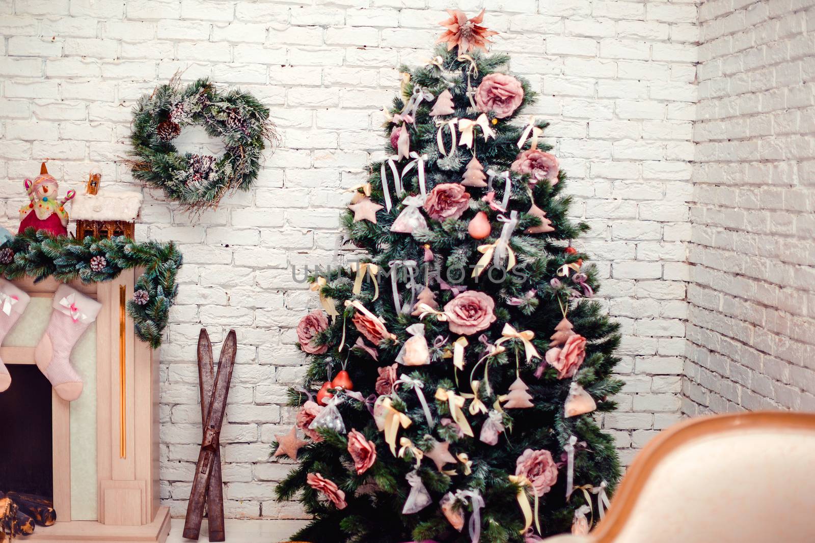 Beautiful holdiay decorated room with Christmas tree with presents under it