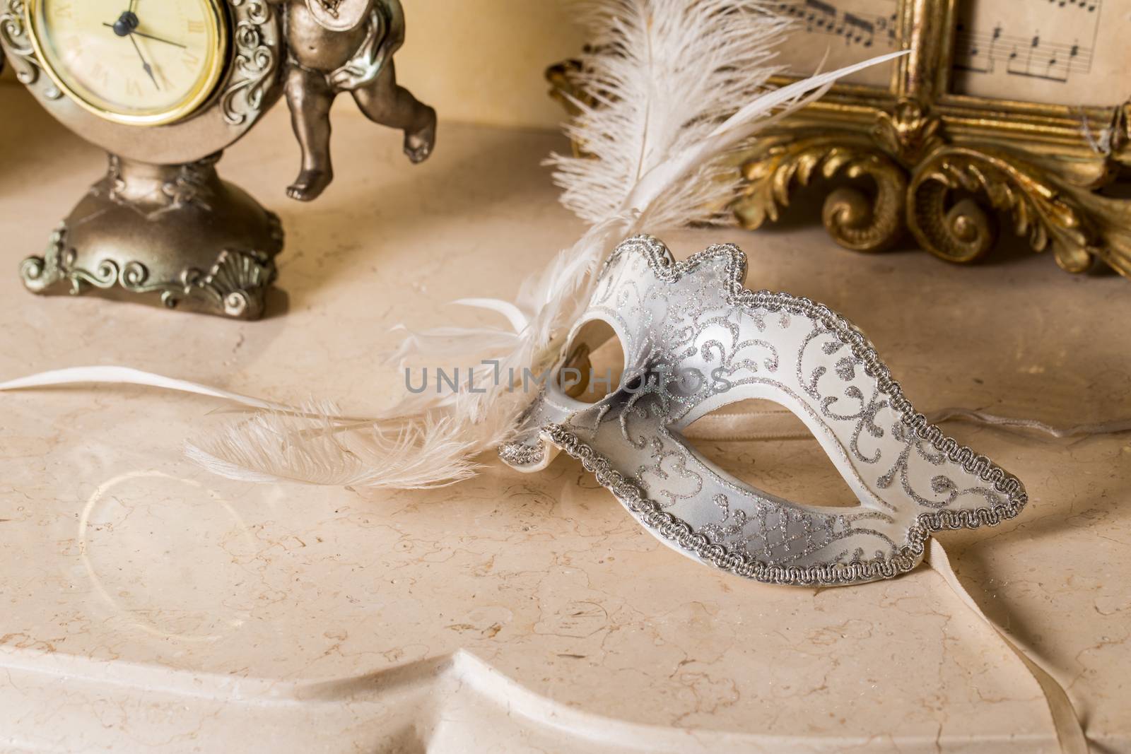 Traditional female carnival venetian mask on table .