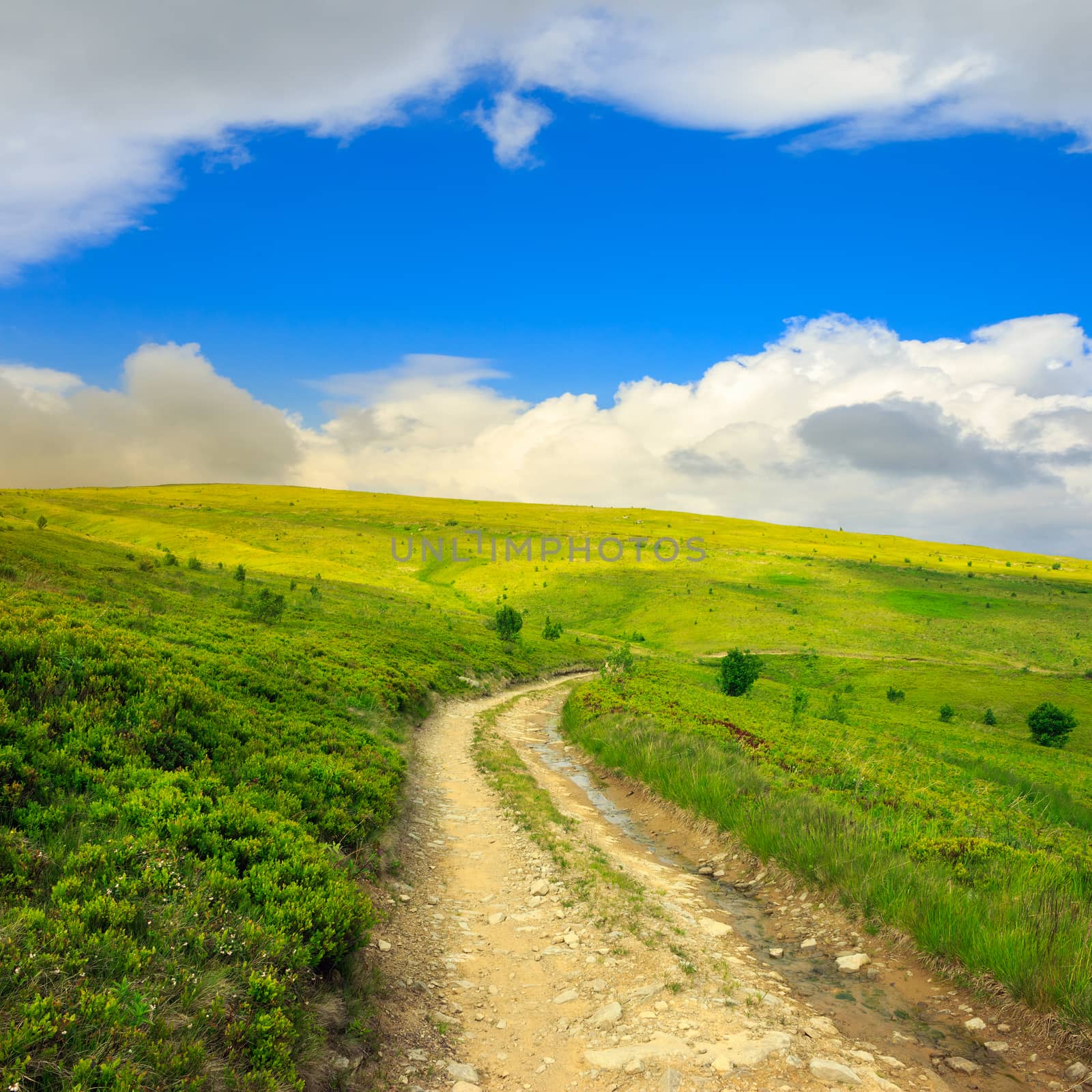 gravel road going on hillside to highlands