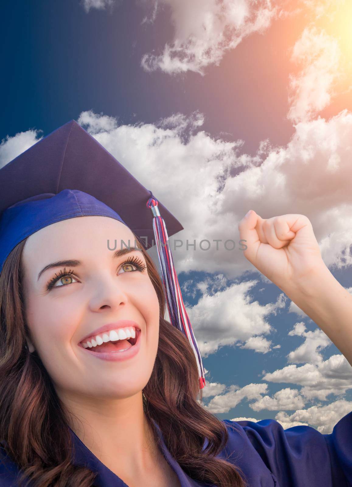 Happy Graduating Mixed Race Woman In Cap and Gown.