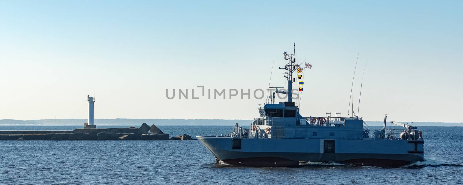 Small grey military ship moving from Baltic sea