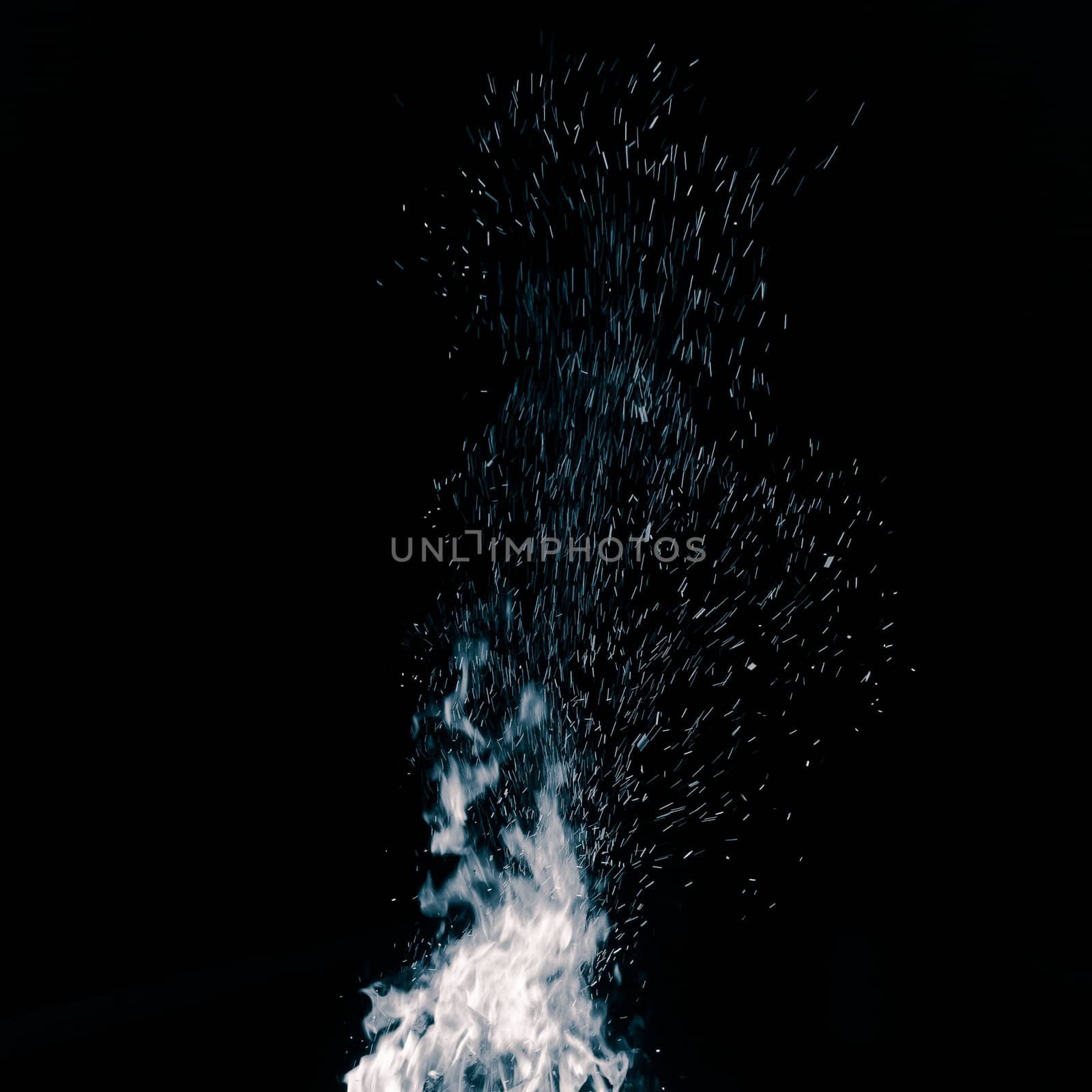 Blue bonfire with flying sparks isolated on black