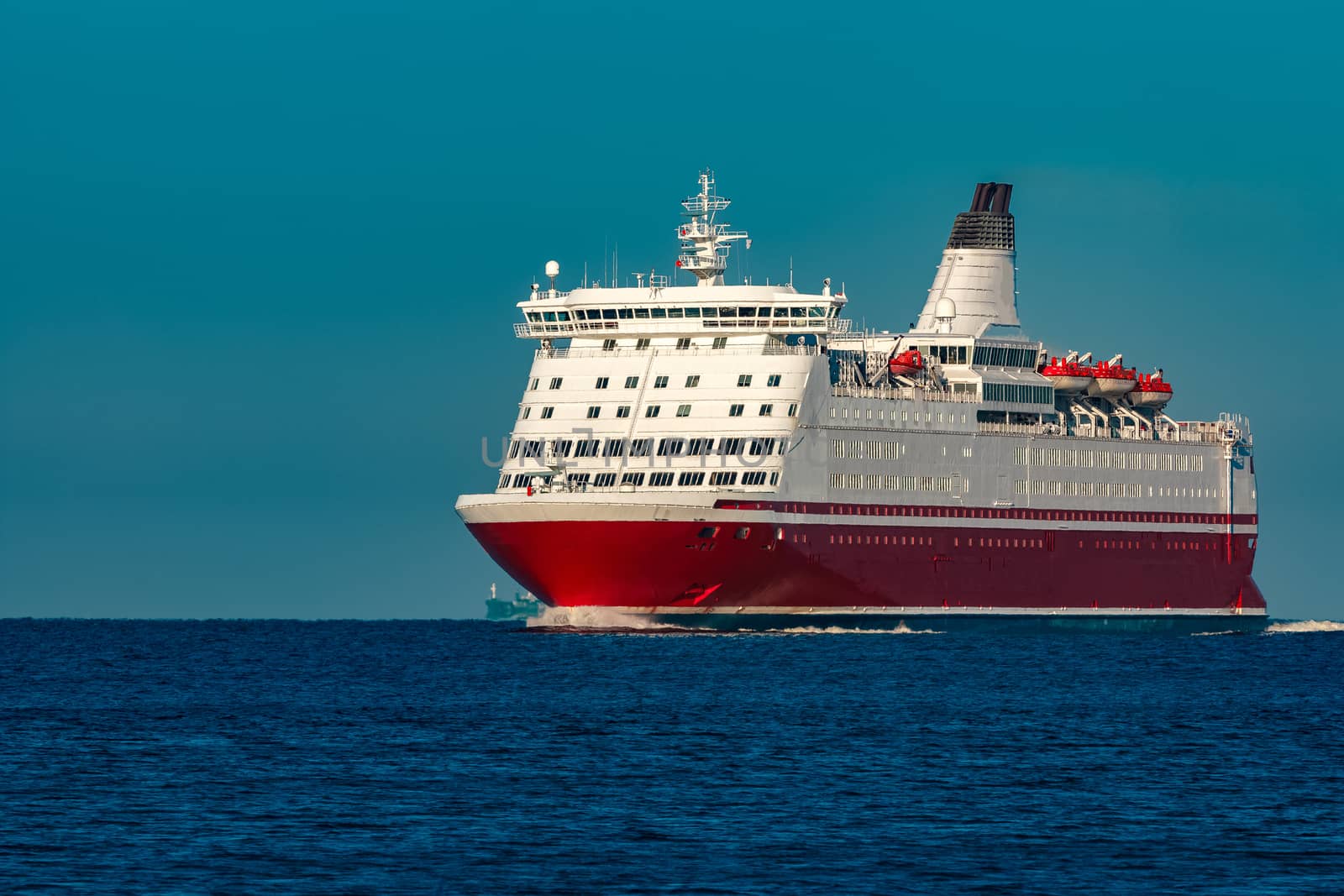 Red cruise liner. Large passenger ferry underway