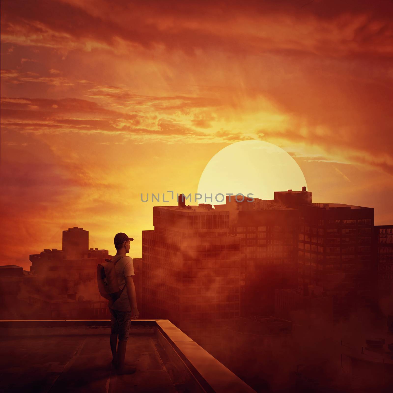 Young boy stay on the rooftop looking at the sunset. Mysterious place over the misty city