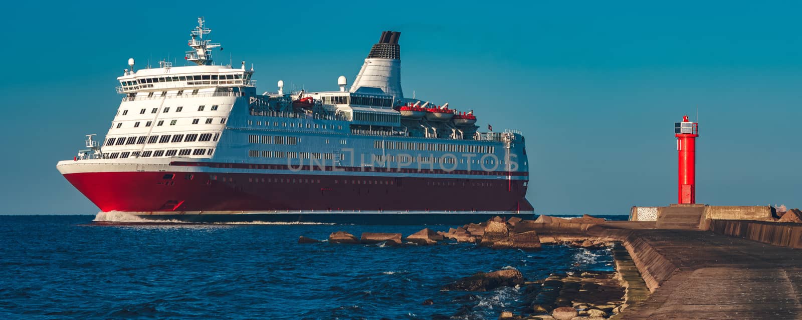 Red cruise liner. Large passenger ferry underway