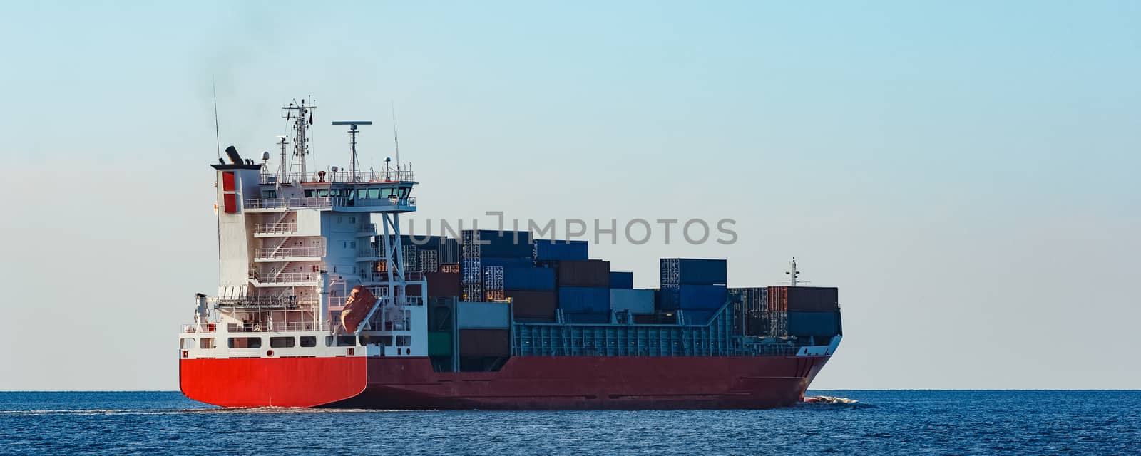 Red container ship sailing to the Baltic sea