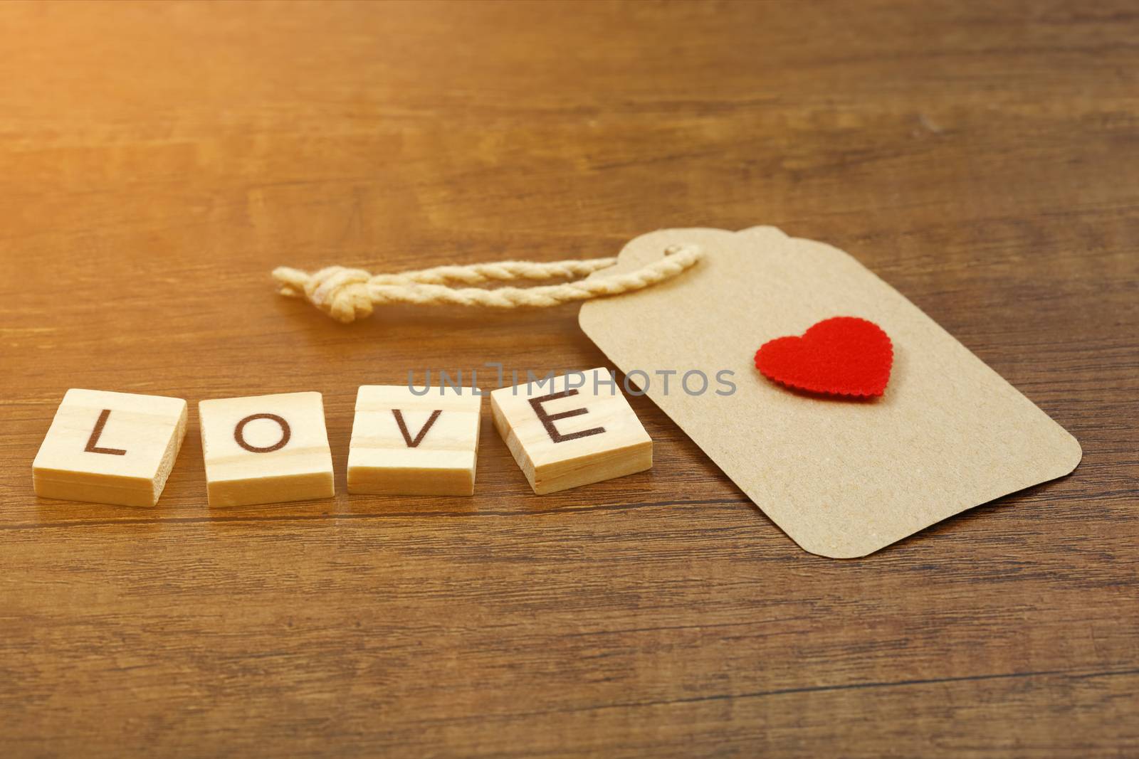 Love wording with red heart sign and paper label  by phalakon