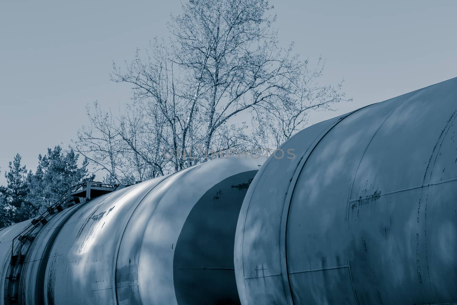 Tank wagons with oil. Freight train in forest